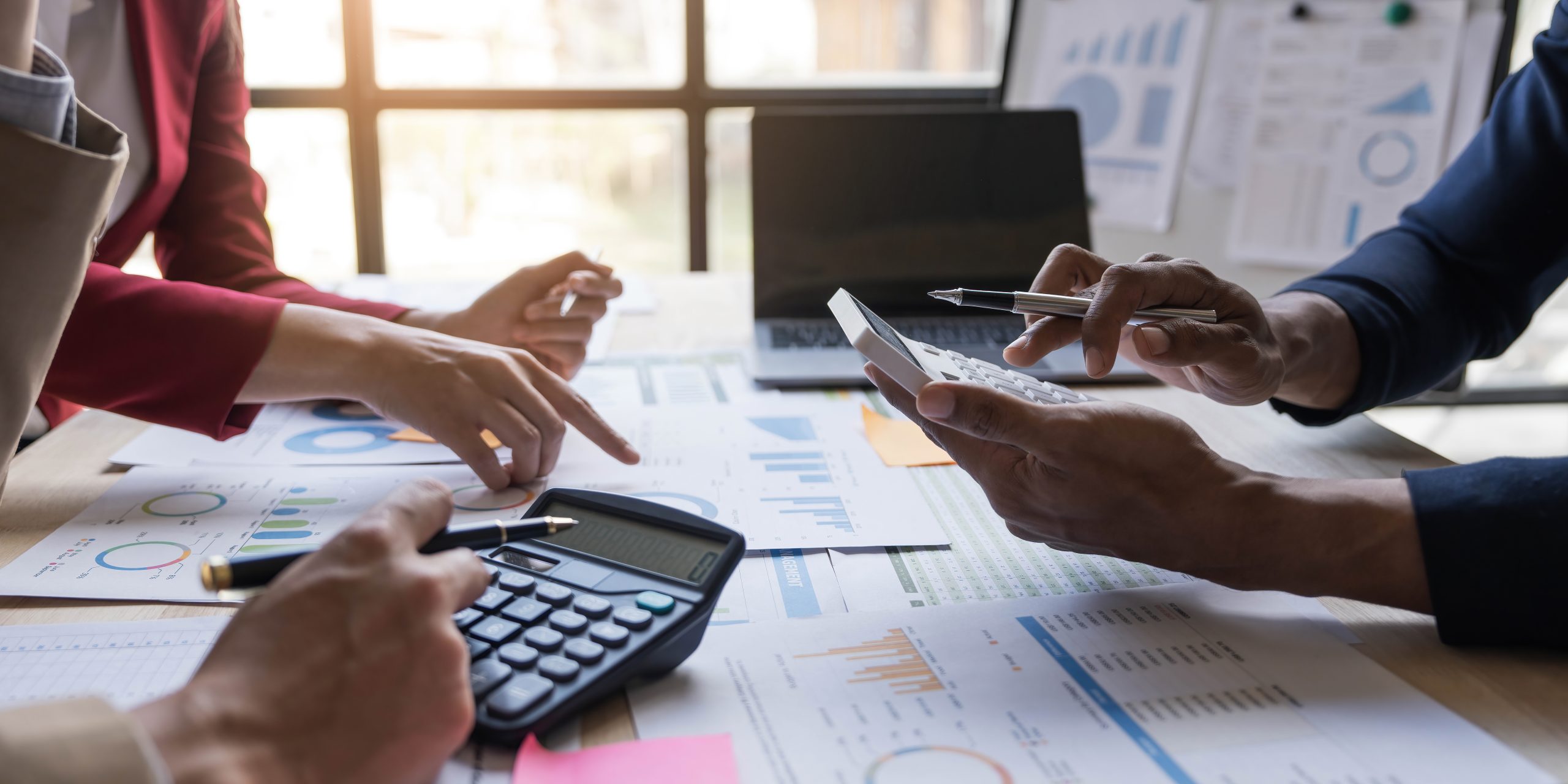 Business financial, accountant discussing with partner are meeting to audit finance planning sales to meet targets set in next year. stock market concept..